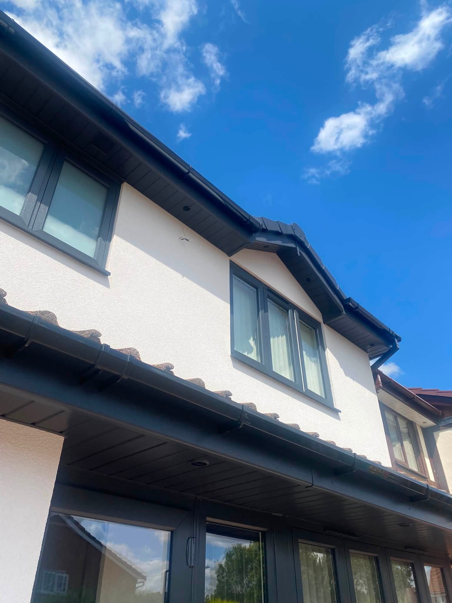 Anthracite grey guttering and fascia roofline detail on rendered property — LDF Fascia & Guttering, Wolverhampton