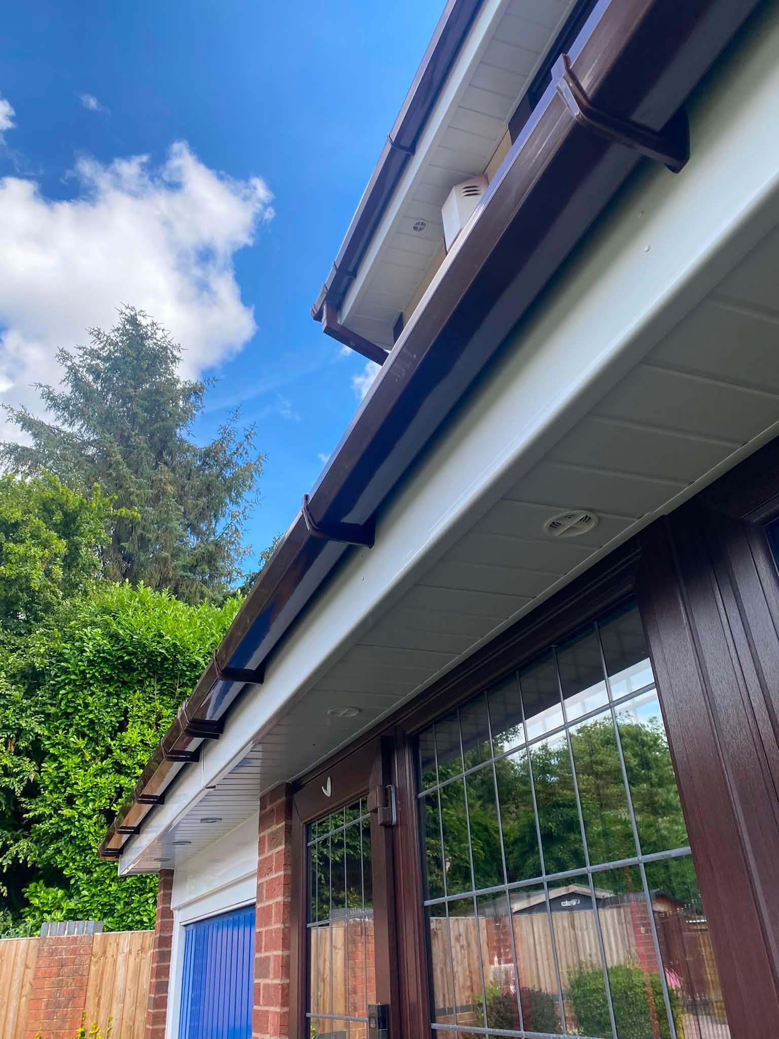 Brown UPVC gutter and downpipe replacement with matching fascia board — roofline specialists, Wolverhampton