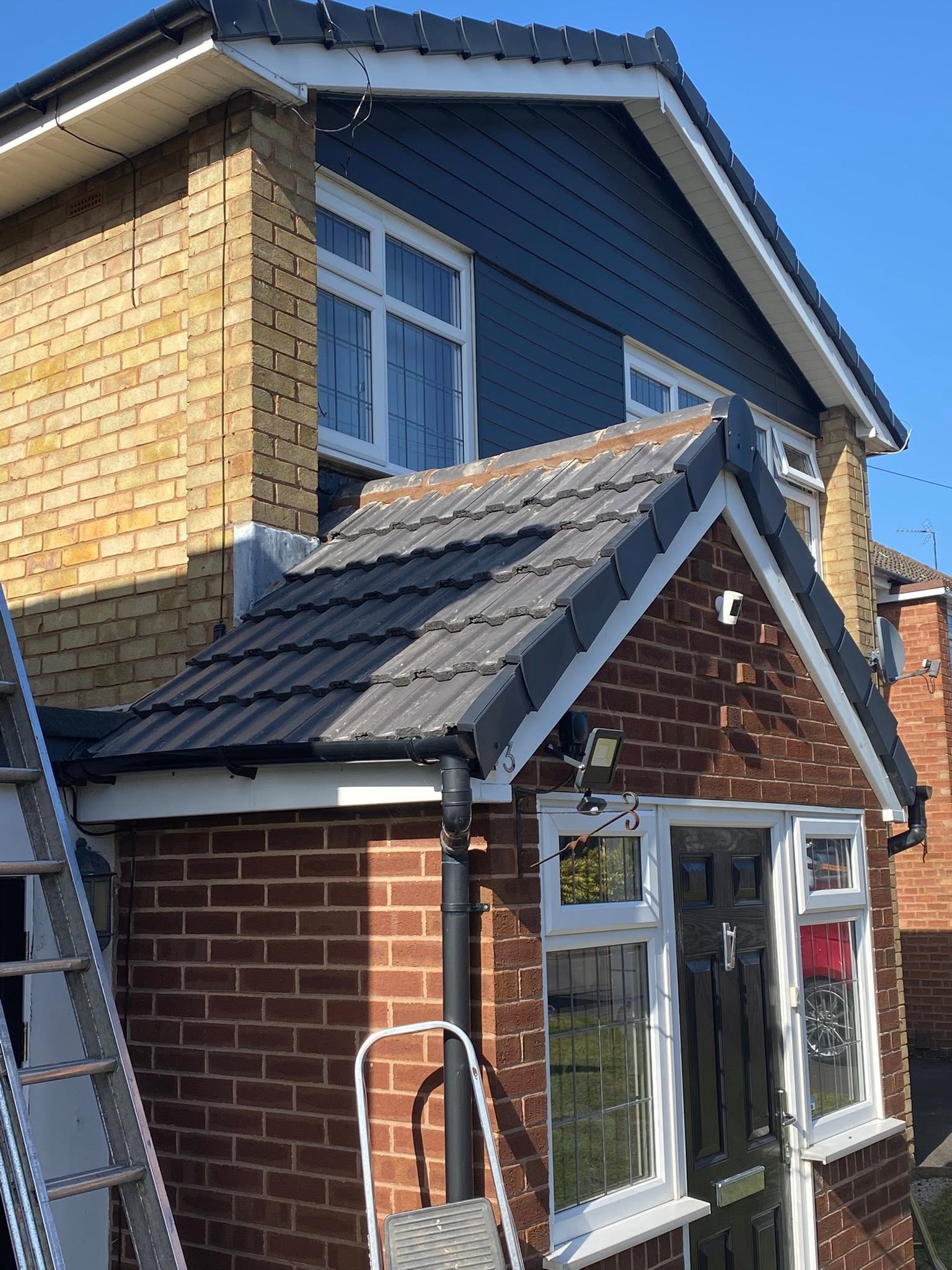 Dry ridge roofline finish with navy blue UPVC cladding to gable — LDF Fascia & Guttering, Wolverhampton