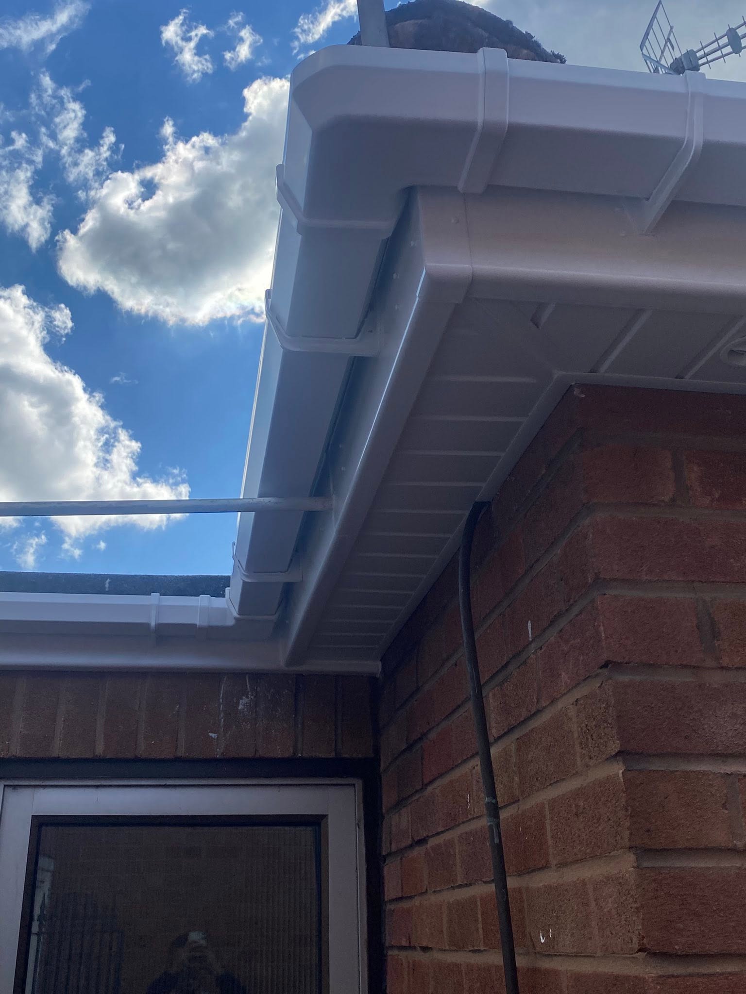 Close-up of white UPVC guttering corner joint and soffit board detail — Wolverhampton guttering specialists