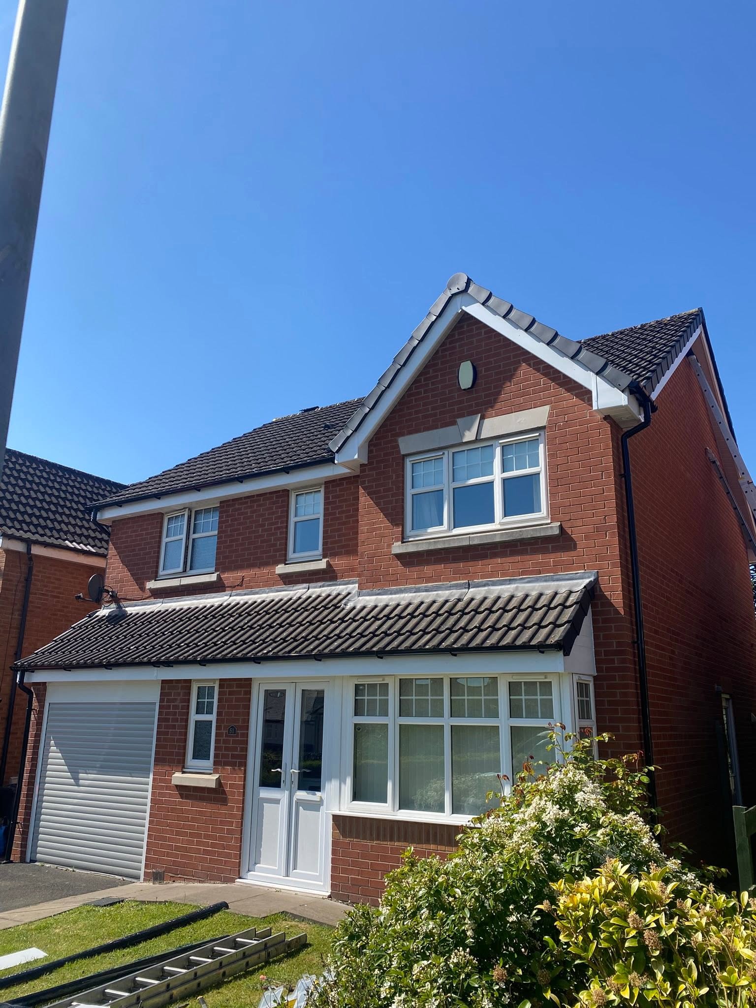 Detached brick house in Wolverhampton with new white UPVC fascia, soffit and guttering fitted by LDF Fascia & Guttering